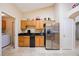 Cozy kitchen with oak cabinets, granite counters, and stainless steel refrigerator at 2043 Wrangler Dr, Brandon, FL 33511