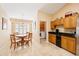 Bright kitchen with dining area featuring wood table and chairs, oak cabinets and black appliances at 2043 Wrangler Dr, Brandon, FL 33511