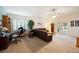 Spacious living room featuring plush brown sectional sofa, large window and ceiling fan at 2043 Wrangler Dr, Brandon, FL 33511