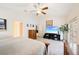 Bright main bedroom with vaulted ceiling, ceiling fan, and large TV at 2043 Wrangler Dr, Brandon, FL 33511