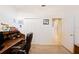 Cozy office space with wooden desk, closet, and white doors leading to hallway at 2043 Wrangler Dr, Brandon, FL 33511