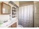 Bathroom featuring a sink, mirror, toilet and shower at 214 W Hanna Ave # A, Tampa, FL 33604