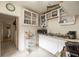 A cozy kitchen space featuring functional white cabinets, essential appliances, and easy-to-clean tile flooring at 214 W Hanna Ave # A, Tampa, FL 33604