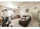 A living room featuring tile floors, a ceiling fan, and a large window providing natural light at 214 W Hanna Ave # A, Tampa, FL 33604