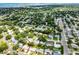 Aerial view showcases the home's location within a lush, green neighborhood with a glimpse of the bay at 2481 12Th Sw Ave, Largo, FL 33770