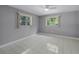 Bright bedroom with ceiling fan and large windows providing natural light and tile floors at 2481 12Th Sw Ave, Largo, FL 33770