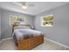 Cozy bedroom with a ceiling fan, light hardwood floors, and two windows providing natural light at 2481 12Th Sw Ave, Largo, FL 33770
