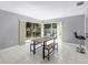 Bright dining area with large windows and tiled floor, features a modern table set with benches at 2481 12Th Sw Ave, Largo, FL 33770