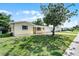 Charming single-story home with a well-maintained lawn and mature tree at 2481 12Th Sw Ave, Largo, FL 33770