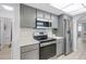 Well-equipped kitchen featuring stainless steel appliances, grey cabinets, and a clean, modern design at 2481 12Th Sw Ave, Largo, FL 33770