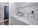 Laundry room with modern washer and dryer and a walk-in shower at 2481 12Th Sw Ave, Largo, FL 33770