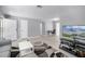Spacious living area with light wood flooring, neutral walls, and modern furnishings for comfortable living at 2481 12Th Sw Ave, Largo, FL 33770