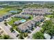 Beautiful aerial view of townhomes, lush green landscaping, and a sparkling community pool at 2487 Golden Pasture Cir, Clearwater, FL 33764