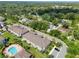 Aerial view showcasing the community's townhomes, pool area, and surrounding landscape at 2487 Golden Pasture Cir, Clearwater, FL 33764