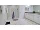 Bright bathroom features a glass shower, double sinks, marble floors and plenty of storage at 2487 Golden Pasture Cir, Clearwater, FL 33764