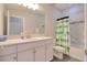 Bright bathroom features a sink and tub/shower combination with green accents at 2487 Golden Pasture Cir, Clearwater, FL 33764