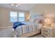 Cozy bedroom with natural light from a window, light furnishings and modern decor at 2487 Golden Pasture Cir, Clearwater, FL 33764