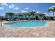 Community pool area with a flamingo float and tropical landscaping at 2487 Golden Pasture Cir, Clearwater, FL 33764