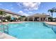 Large community pool with lounge chairs, covered areas, and lush landscaping at 2487 Golden Pasture Cir, Clearwater, FL 33764