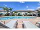 View of the community pool area with plenty of lounge chairs for residents at 2487 Golden Pasture Cir, Clearwater, FL 33764