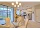 Cozy dining area beside a modern kitchen with stainless steel appliances and white cabinets at 2487 Golden Pasture Cir, Clearwater, FL 33764