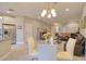 Bright dining area with a glass-top table, leading into the adjacent living room and kitchen at 2487 Golden Pasture Cir, Clearwater, FL 33764