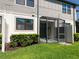 Home exterior showing a screened in patio area and manicured lawn at 2487 Golden Pasture Cir, Clearwater, FL 33764