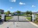 Gated entrance to the community with well-maintained landscaping and attractive streetscape at 2487 Golden Pasture Cir, Clearwater, FL 33764