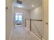 Hallway looking into bedroom with carpet and wood-white banister at 2487 Golden Pasture Cir, Clearwater, FL 33764