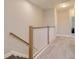 Upstairs hallway with carpet and a staircase with wood and white bannister at 2487 Golden Pasture Cir, Clearwater, FL 33764