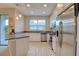 Modern kitchen featuring stainless steel appliances, white cabinetry, and light countertops at 2487 Golden Pasture Cir, Clearwater, FL 33764