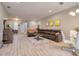 Open-concept living space with sleek tile flooring, comfortable furnishings, and a dining area at 2487 Golden Pasture Cir, Clearwater, FL 33764