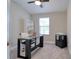 Bright office with a glass-top desk and a built-in bookcase at 2487 Golden Pasture Cir, Clearwater, FL 33764