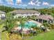 Aerial view of the community pool and amenity center with lush landscaping and palm trees at 2487 Golden Pasture Cir, Clearwater, FL 33764