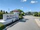 The Towns at Belleair Grove sign with manicured landscaping and community entrance at 2487 Golden Pasture Cir, Clearwater, FL 33764