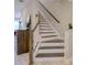 Staircase featuring wood and white accents and modern design at 2487 Golden Pasture Cir, Clearwater, FL 33764