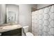 Bathroom with a granite vanity and shower-tub combination, white toilet, and decorative shower curtain at 2513 Knight Island Dr, Brandon, FL 33511