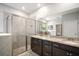 A bathroom with dual sink vanity with granite counters and a tiled shower enclosure at 2513 Knight Island Dr, Brandon, FL 33511
