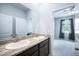 Bathroom featuring a double vanity with granite countertops and tile flooring and a bedroom view at 2513 Knight Island Dr, Brandon, FL 33511