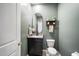 Charming powder room with a modern oval mirror and dark vanity at 2513 Knight Island Dr, Brandon, FL 33511