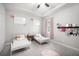Comfortable bedroom with two twin beds and pink accents, a ceiling fan and natural light at 2513 Knight Island Dr, Brandon, FL 33511