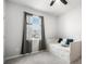 Cozy bedroom with a white trundle bed, gray curtains, carpet flooring and natural light at 2513 Knight Island Dr, Brandon, FL 33511