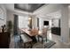 Elegant dining room featuring a modern chandelier, a large wooden table, and an area rug at 2513 Knight Island Dr, Brandon, FL 33511