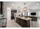 Modern kitchen island with granite countertops, dark cabinetry, and open layout to the living area at 2513 Knight Island Dr, Brandon, FL 33511