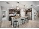 Spacious kitchen featuring dark cabinets, a center island with bar stools, and stainless steel appliances at 2513 Knight Island Dr, Brandon, FL 33511