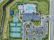Aerial view showcasing pool, tennis courts, playground, clubhouse, and parking at 3197 Acacia Bay Ave, Wesley Chapel, FL 33543