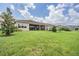Spacious backyard with well-manicured lawn and screened patio for outdoor entertaining at 3197 Acacia Bay Ave, Wesley Chapel, FL 33543