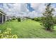 Expansive backyard featuring a pond, manicured lawn, and lush landscaping, creating a private and serene oasis at 3197 Acacia Bay Ave, Wesley Chapel, FL 33543