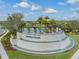 Inviting entrance to Winding Ridge with lush landscaping and water feature at 3197 Acacia Bay Ave, Wesley Chapel, FL 33543
