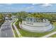 Panoramic view of the community entrance with water feature and landscaping at 3197 Acacia Bay Ave, Wesley Chapel, FL 33543